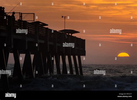 Jacksonville Beach fishing pier during sunrise Stock Photo - Alamy