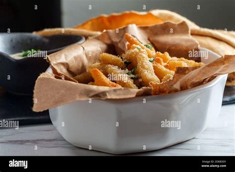 New England fried clam strips served with a bowl of tartar dipping sauce Stock Photo - Alamy