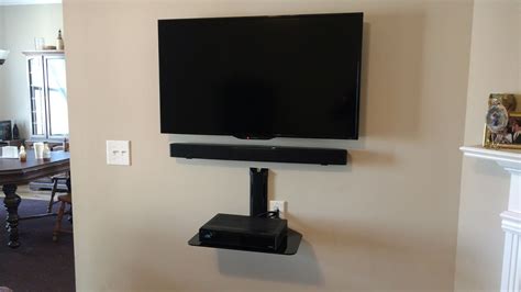 TV, soundbar and glass shelf installation for a client in the ...