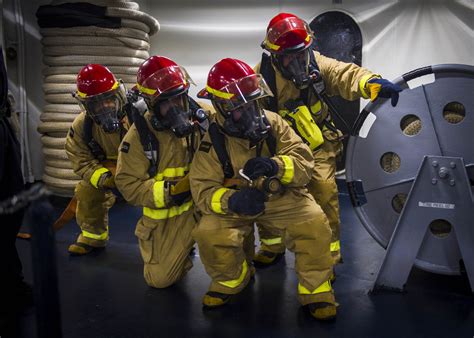 Sailors man a fire hose during a general quarters drill ab… | Flickr