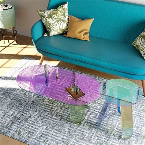 a living room with blue couch, coffee table and colorful rug