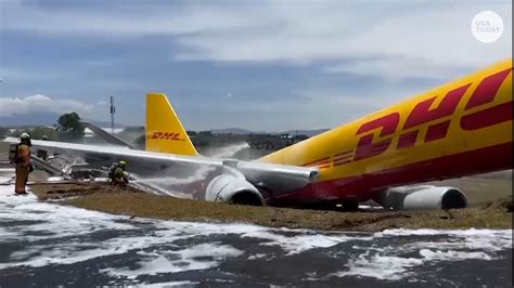 DHL cargo plane skids off runway, breaks in half during rough landing