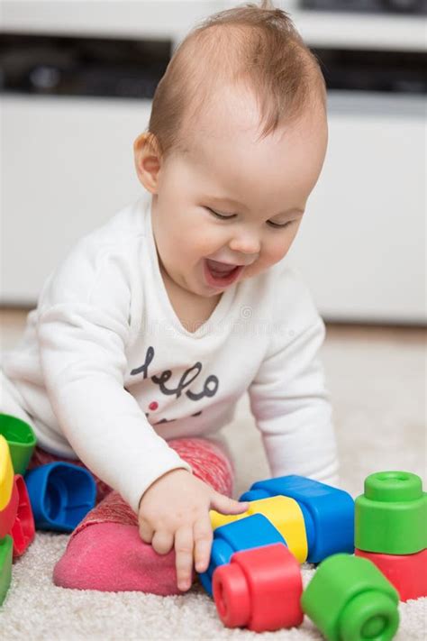 Nine Months Old Baby Girl Sitting on the Floor Stock Photo - Image of childhood, playful: 85206626