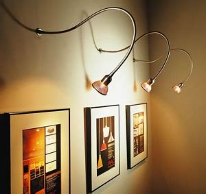 This is an example of accent lighting because it brings attention to the pictures on the wall ...