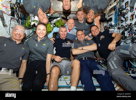 ISS - 30 March 2022 - The ten-member Expedition 66 crew poses for a group portrait aboard the ...