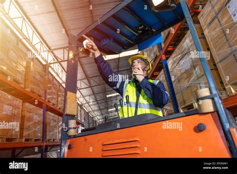 Russian European male staff worker working control loading operate folk lift in warehouse ...