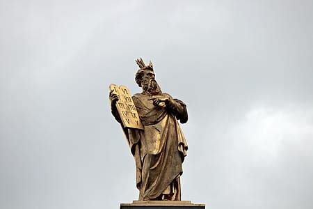 Royalty-Free photo: Man holding book statue | PickPik