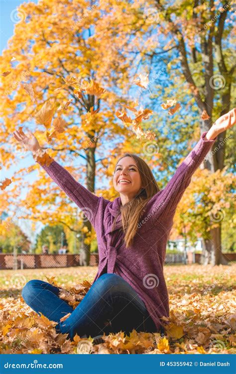 Happy Young Woman Rejoicing in an Autumn Park Stock Photo - Image of autumn, leafs: 45355942