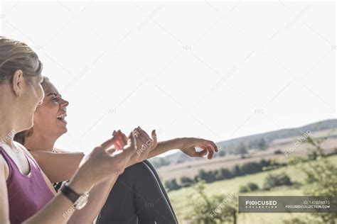 Female friends laughing together — attractive, fitness - Stock Photo ...