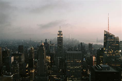 City Skyline Under Gray Sky during Night Time · Free Stock Photo