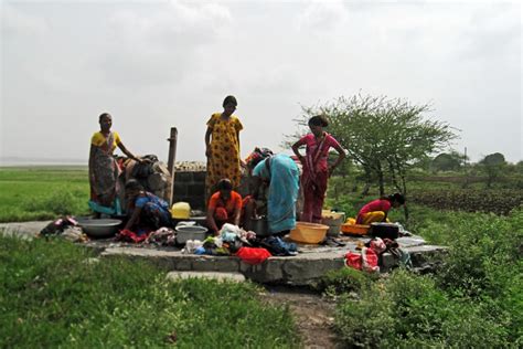 Stock Pictures: Women filling water from village well in India