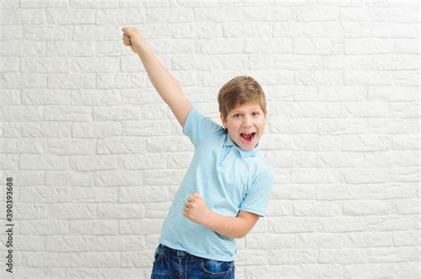 Happy boy making dab arms gesture on white studio background, funny guy ...