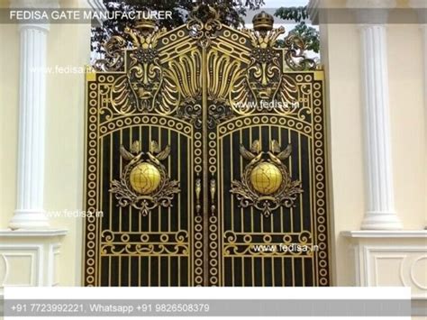 an ornate gold gate in front of a white building