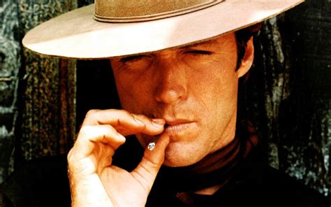 Download Clint Eastwood Cowboy Hat Smoking A Cigarette Wallpaper | Wallpapers.com