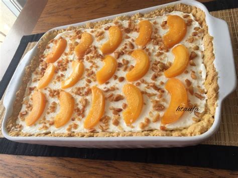 a dessert dish with peaches and cream on top