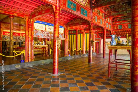 The interior of an ancient temple painted in red and gold with a ...