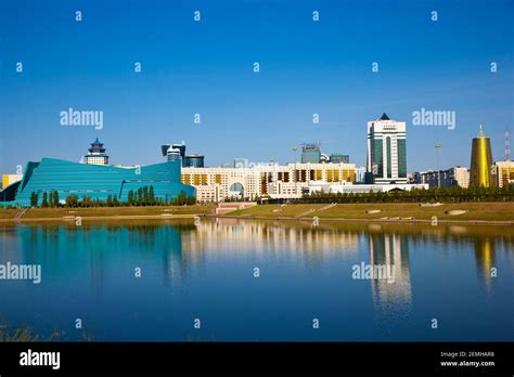 Kazakhstan, Astana, City skyline reflecting in Ishim River, from left to right the Central ...