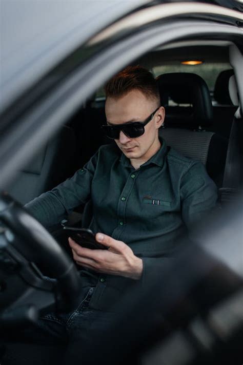 Man Using Smartphone in Car · Free Stock Photo