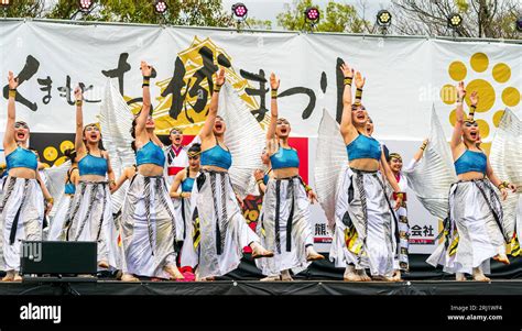 Japanese teenage women Yosakoi dance team in silver and blue costumes ...