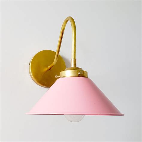 PInk and brass modern farmhouse curved arm sconce with cone shade. This fun wall sconces is ...