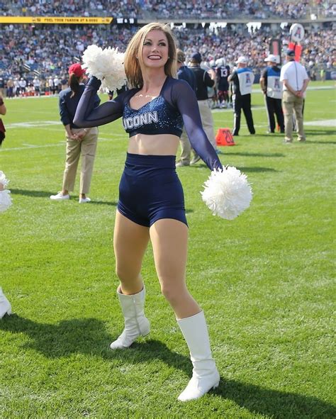 the cheerleaders are performing on the field for the football game in their uniforms