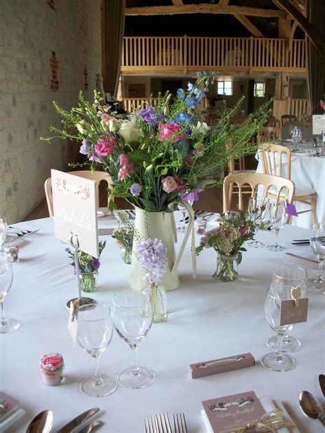 A gorgeous rustic centre piece using a jug and jam jars | Wedding flowers, Pippas wedding ...
