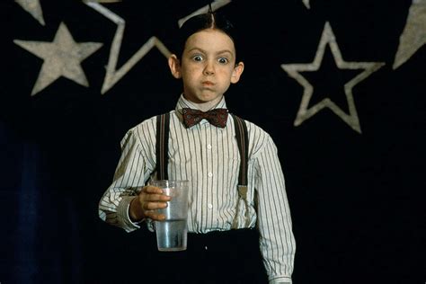 Download A Boy Holding A Glass Of Water | Wallpapers.com