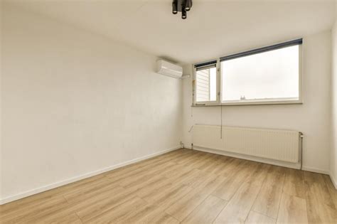 Premium Photo | An empty living room with wood floors and a window