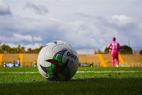 Close-Up Photo of a Football on a Green Grass Field · Free Stock Photo