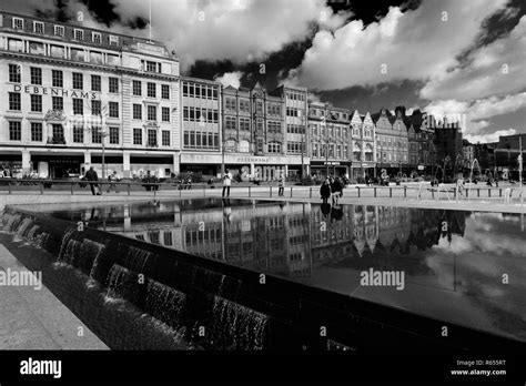 City centre shops reflected in the infinity pool, and fountains, Old Market Square, Nottingham ...