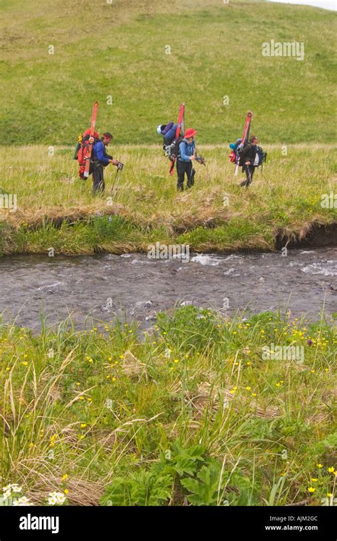 Three skiers hiking in grass on Umnak Island inthe Aleutian Islands Alaska Stock Photo - Alamy