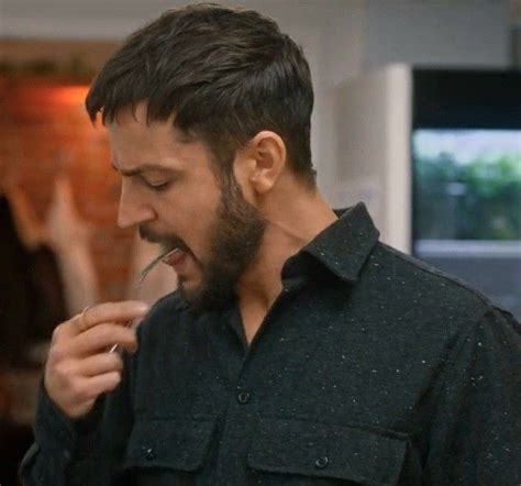 a man with a beard is eating something