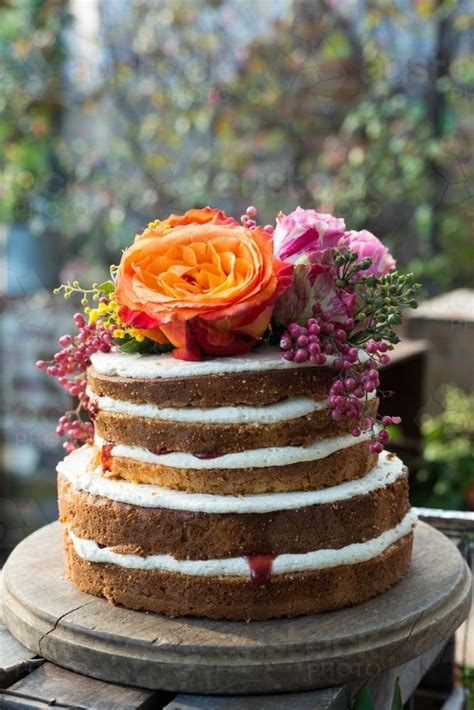 Image of Rustic birthday cake with flowers - Austockphoto