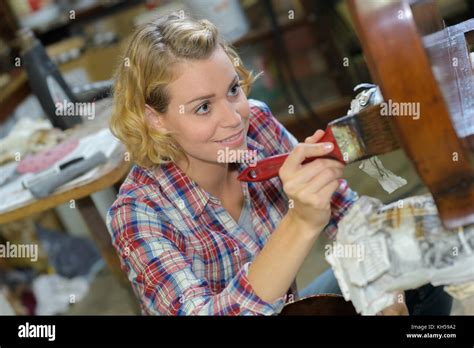 Woman varnishing furniture Stock Photo - Alamy