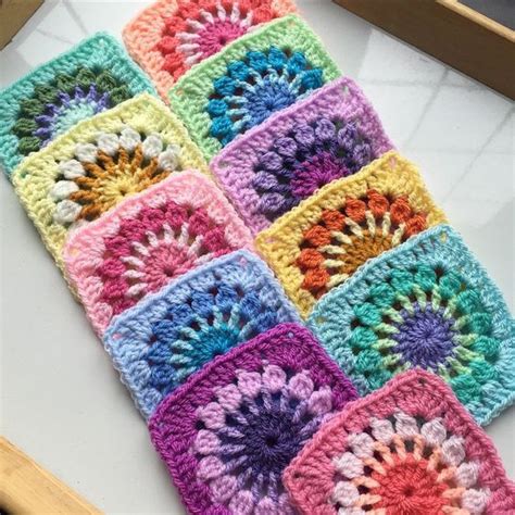 a colorful crocheted square is displayed on a table