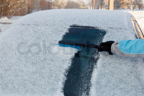 Clearing snow off a car | Stock image | Colourbox