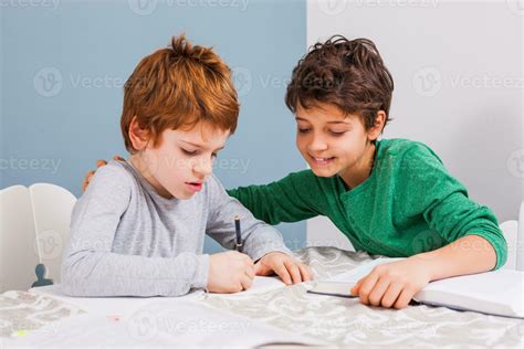 Kids doing homework 23921718 Stock Photo at Vecteezy