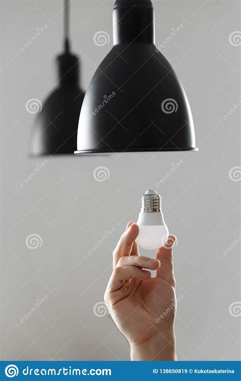 Changing the Bulb for Led Bulb in Floor Lamp in Black Colour. on Light Gray Background Stock ...