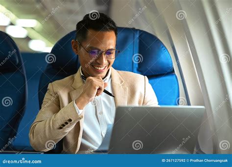 Image of Smiling Businessman in Elegant Luxury Suit Working with Laptop in Aircraft during ...