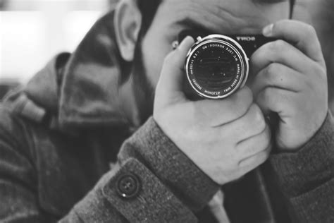 Man Taking Photo Using Black Dslr Camera · Free Stock Photo