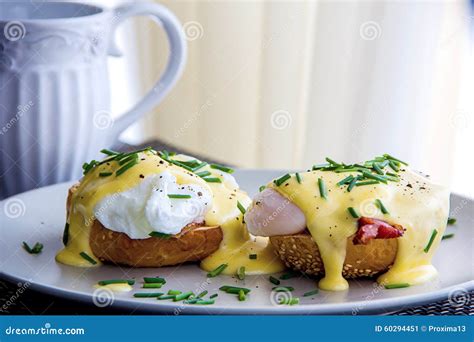 Eggs Benedict- Toasted Muffins, Ham, Poached Eggs, and Delicious Buttery Hollandaise Sauce Stock ...