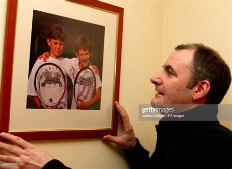 Andy Murray's father Will Murray looks at a picture of his sons Jamie ...