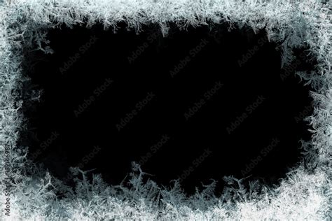 Frostwork. Decorative frostwork ice crystals frame on black background. Can be used as window ...