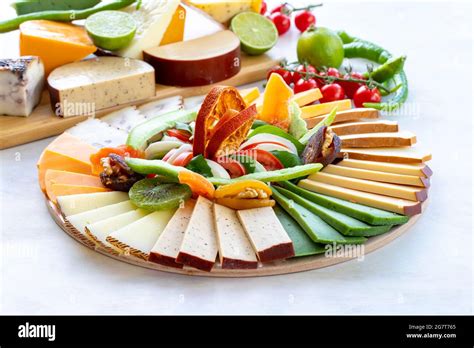 Cheese plate on a white wooden background. Cheese tasting platter. Types of cheese. Cheese plate ...