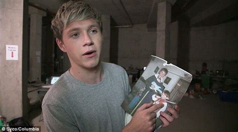 One Direction's Niall Horan holding a childhood photograph of himself ...