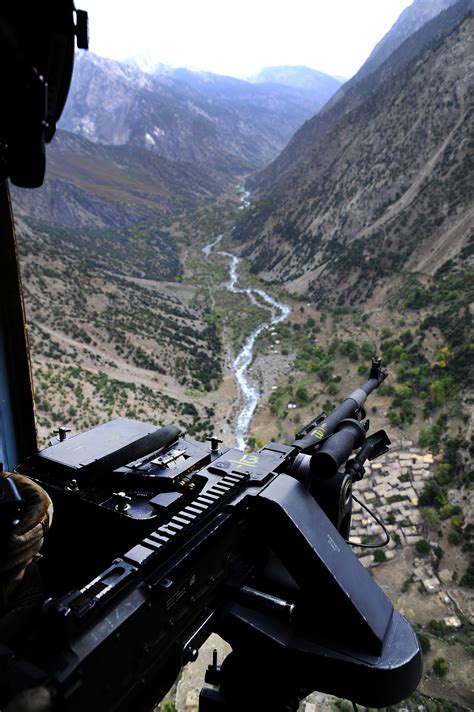 U.S. Air Force Senior Master Sgt. Todd Peplow surveys the surrounding area for possible ...