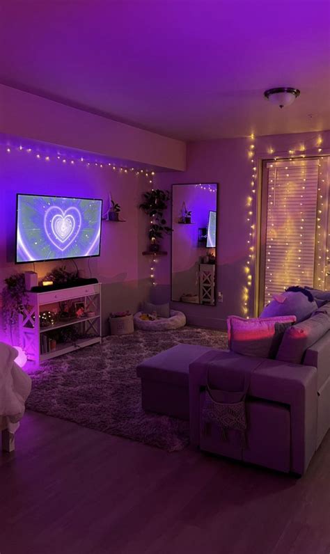 a living room filled with furniture and purple lights on the wall above it is a flat screen tv