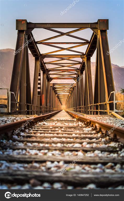 Old metal rail road bridge. With symmetrical metal structure and Stock Photo by ©scalatore959 ...