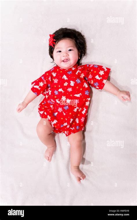 baby girl with cute red Japanese style outfit and white background ...