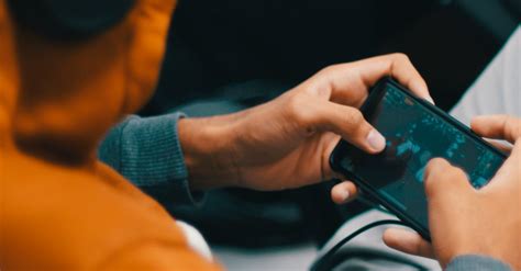 Person Playing Games On His Phone · Free Stock Photo